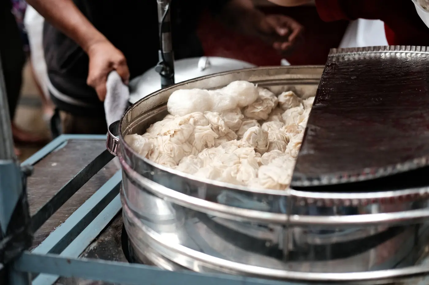 Momos steaming in a street-side steamer